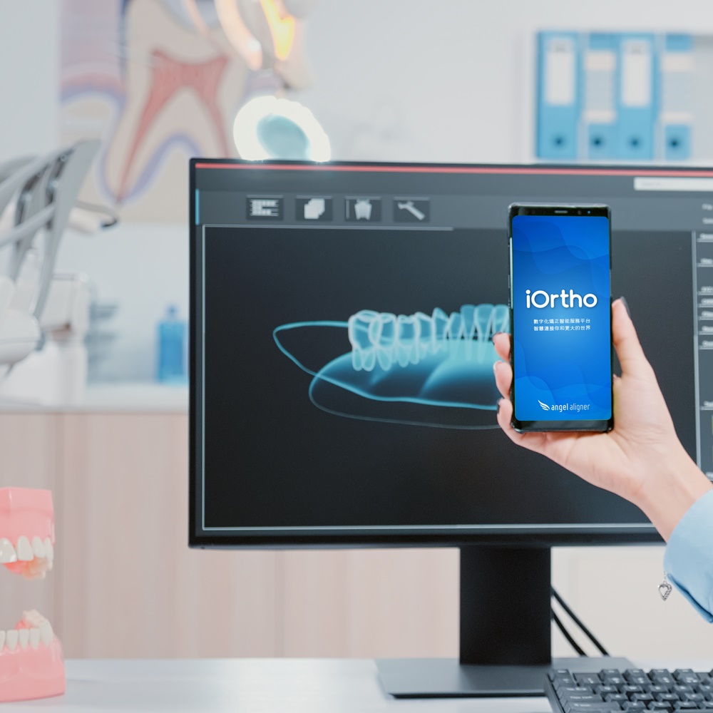 Woman working as dentist with green screen on smartphone in oral care office. Dentist holding mobile phone with mockup template and isolated background for teethcare and dentistry.